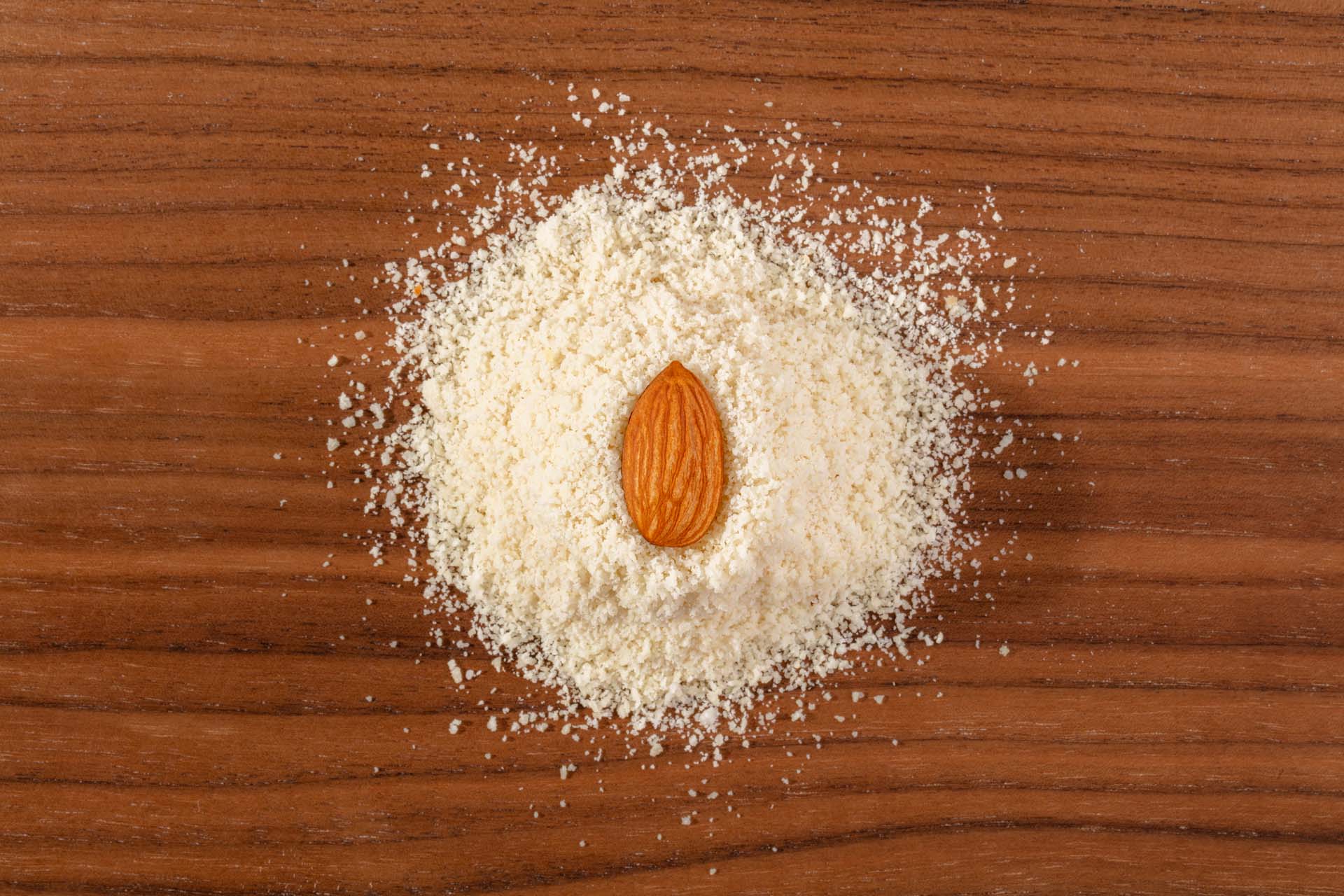 Whole Almond in a Pile of Organic Blanched Almond Flour